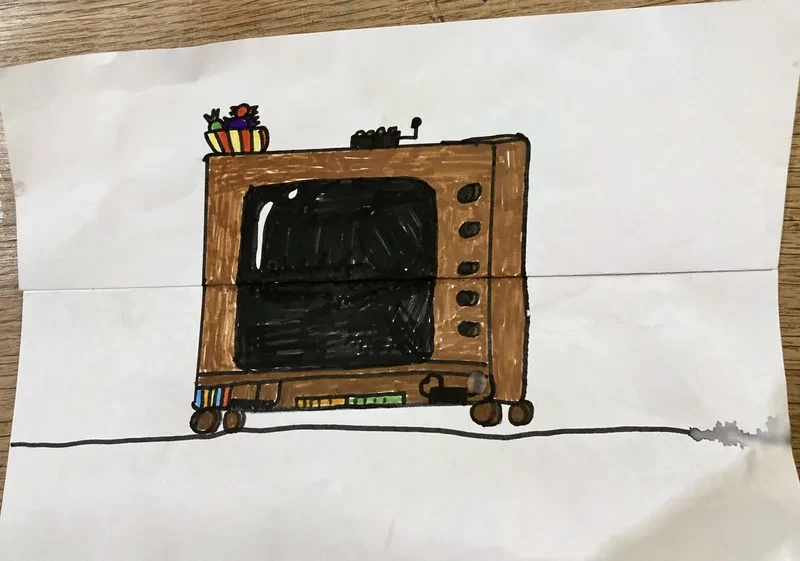 Old tv on brown cabinet